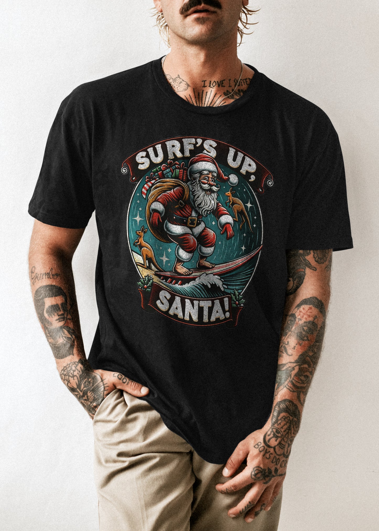 A photo of a tshirt with a print of Santa surfing with Kangaroos in the background