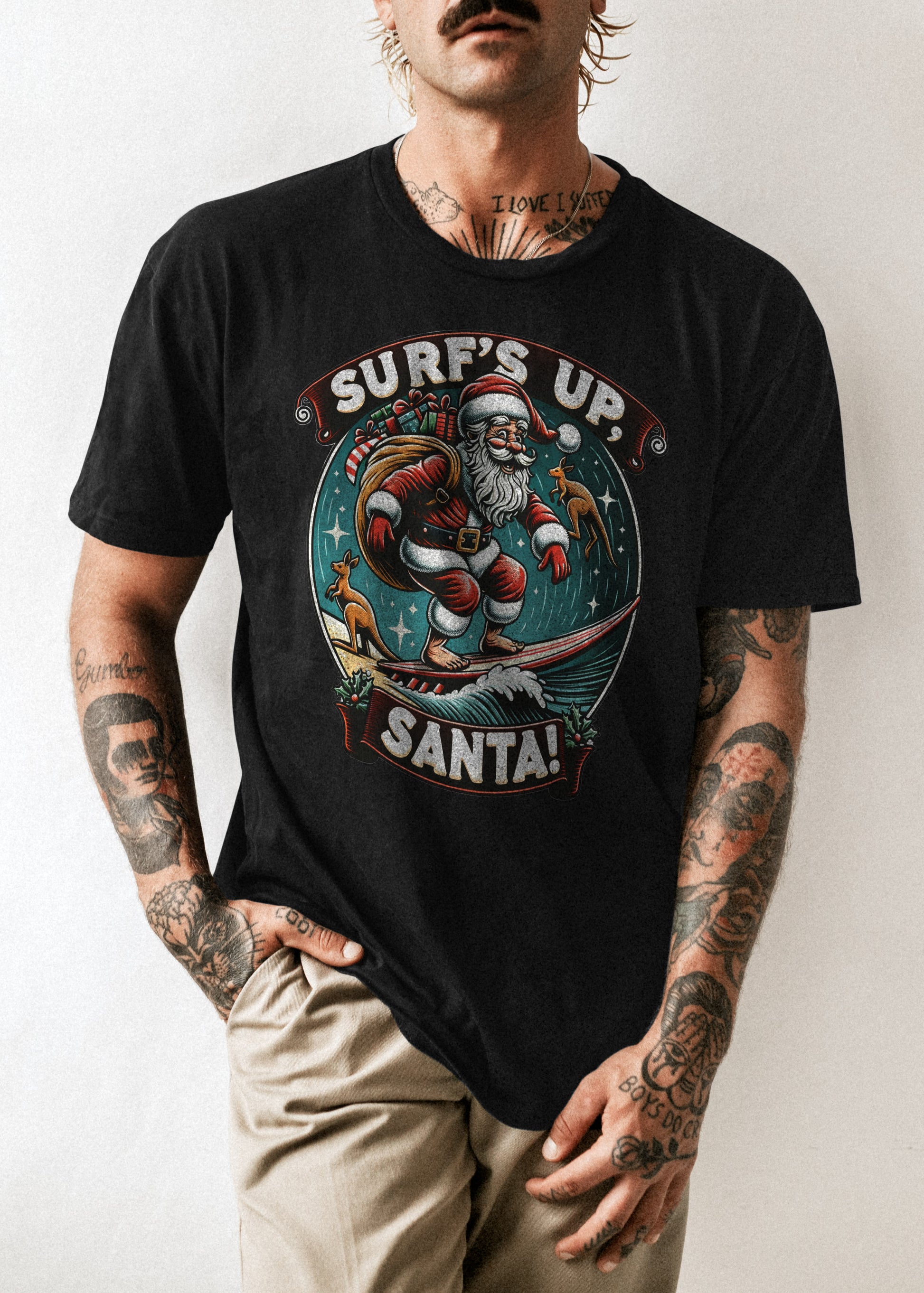 A photo of a tshirt with a print of Santa surfing with Kangaroos in the background